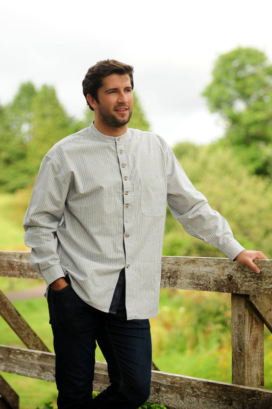 Striped cotton shirt with a stand collar, sold in London, Ontario, shown on an Irish bloke leaning on a fence. Shirt is for men or women.